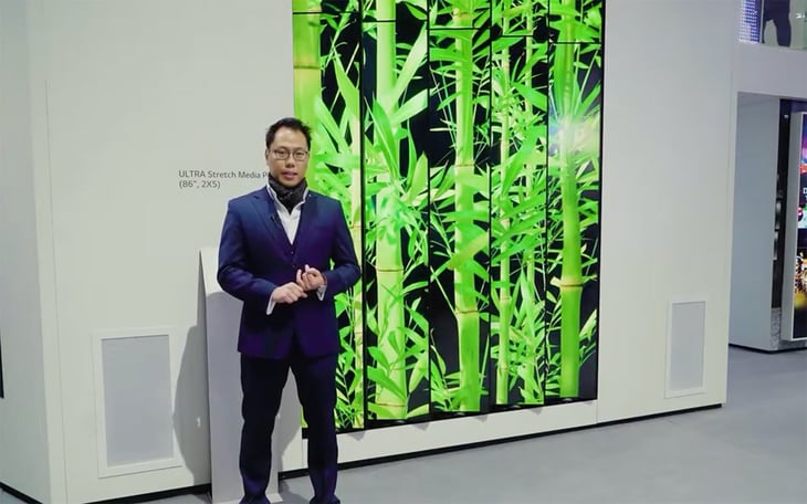 man standing in front of LG ultra stretch tiled display