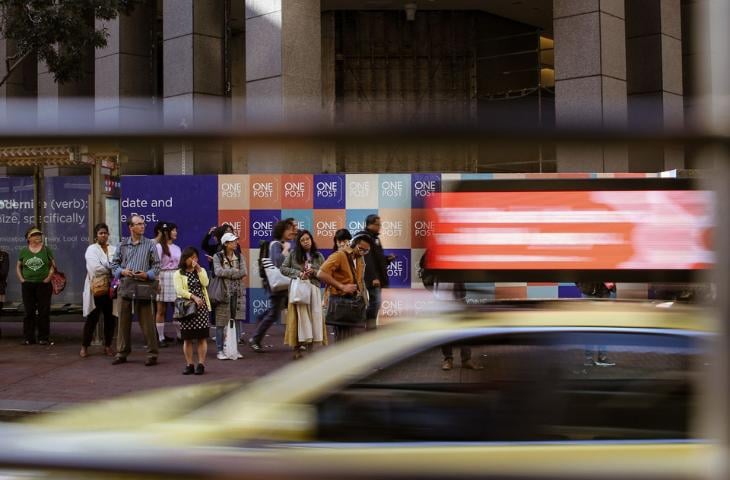 A car with vehicle-mounted signage is driving by.