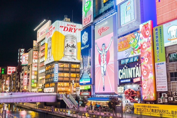 Multiple video walls in the city at night. 