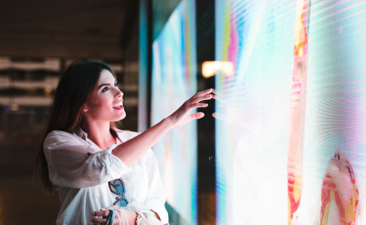 woman pointing on an LED screen