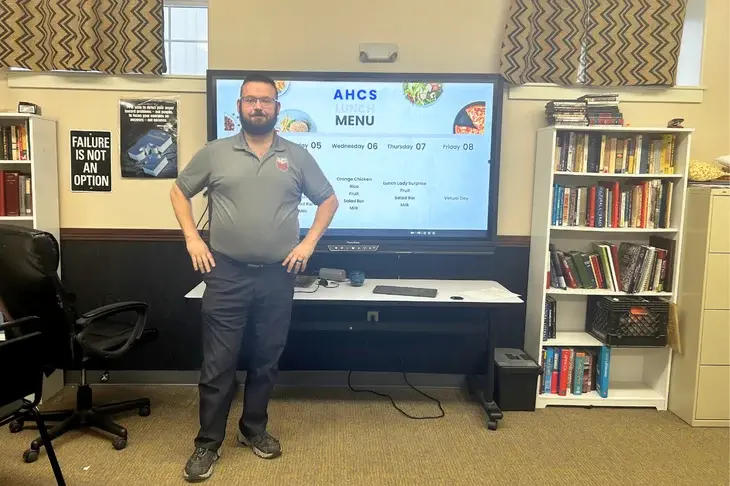 Josh Siqueiros standing in front of a display