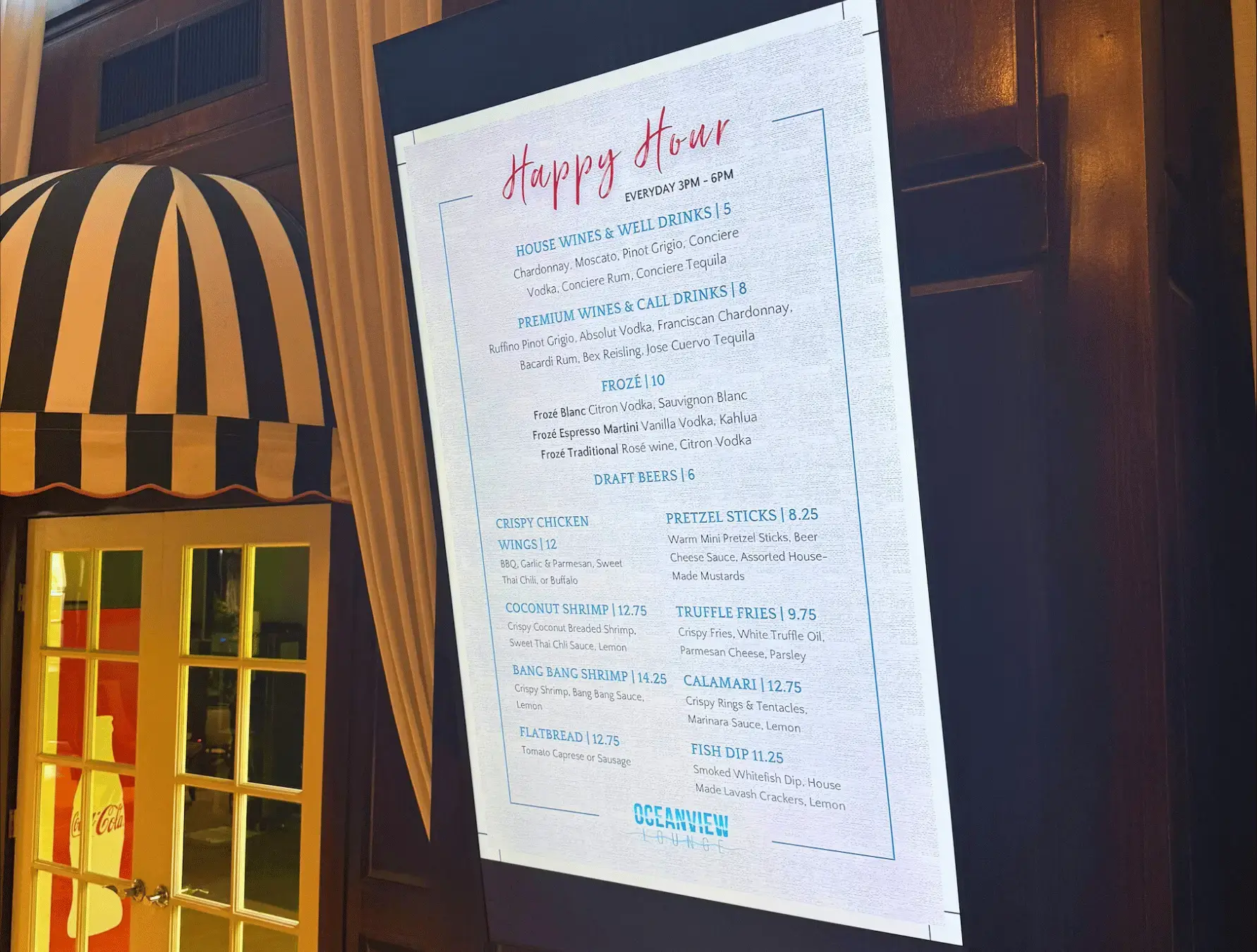 A restaurant using digital signage to showcase a happy hour menu