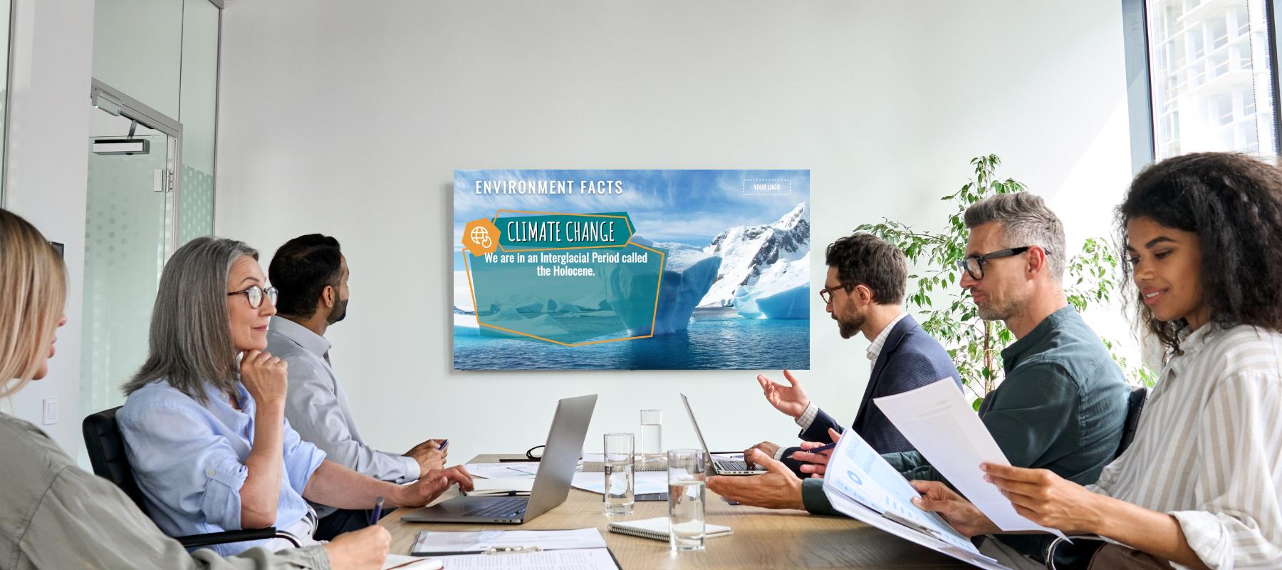 A corporate meeting and people looking at digital signage.