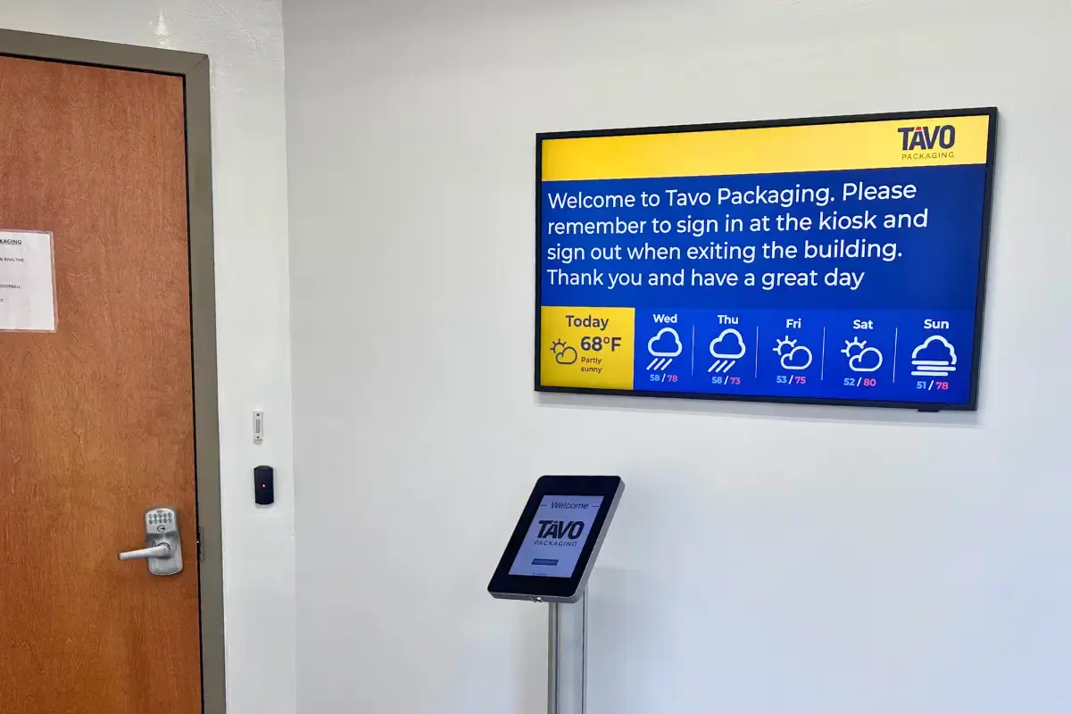 A digital display mounted on a wall displaying weather conditions