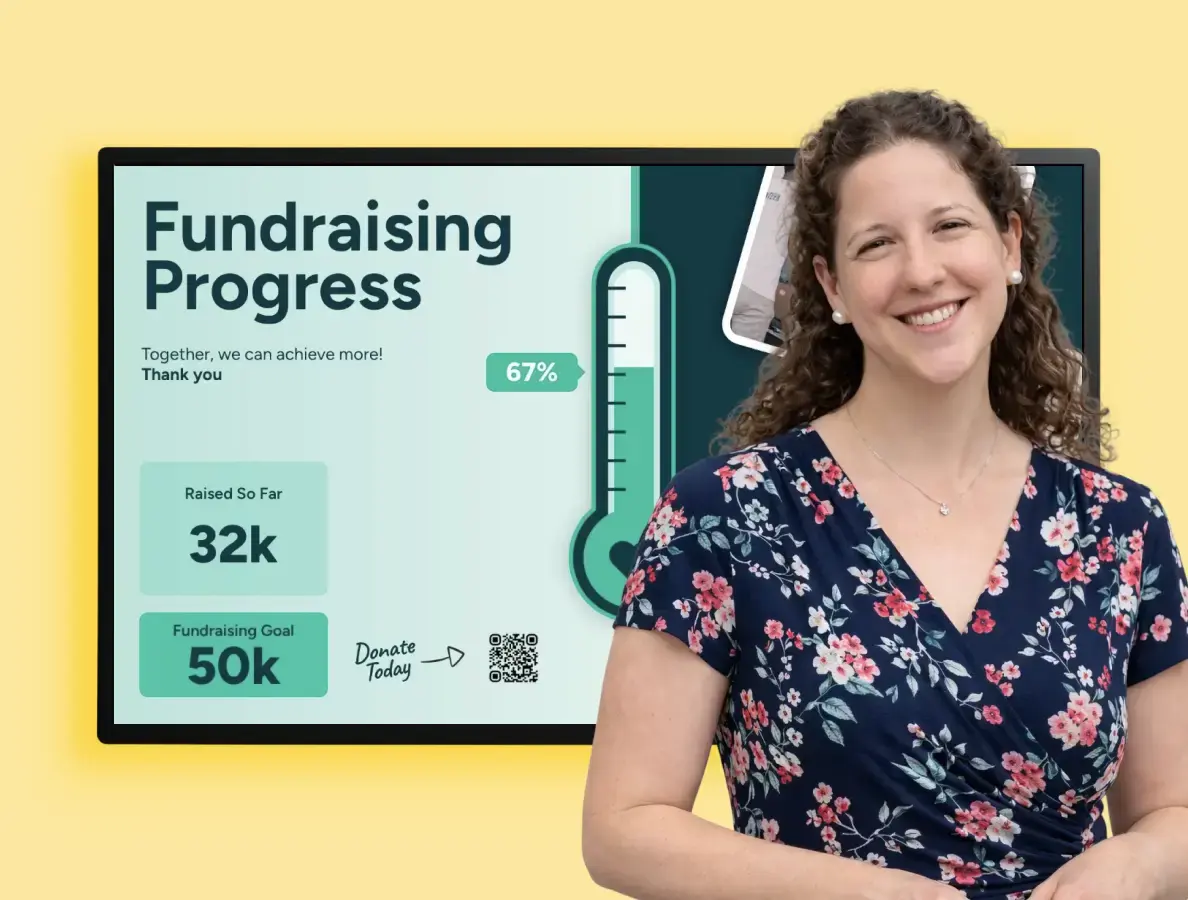 A woman standing in front of a digital display showing fundraising progress