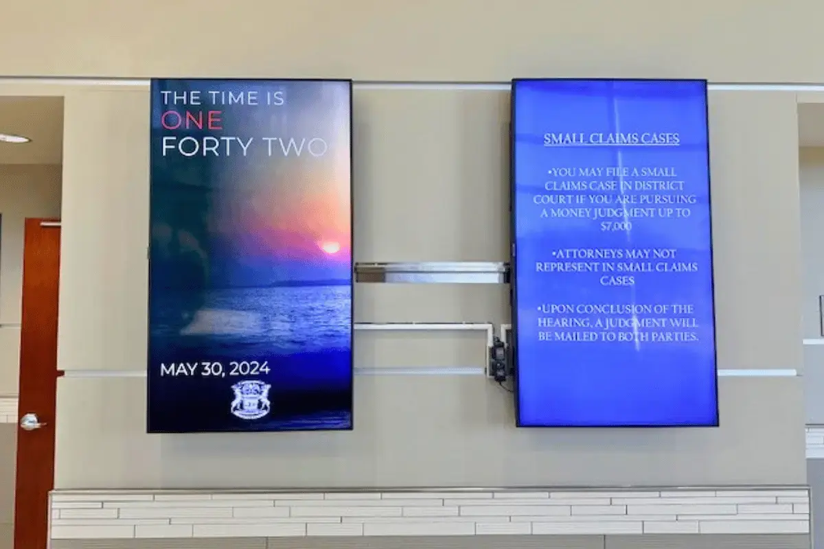 Multiple digital signage displays in portrait mode on a wall