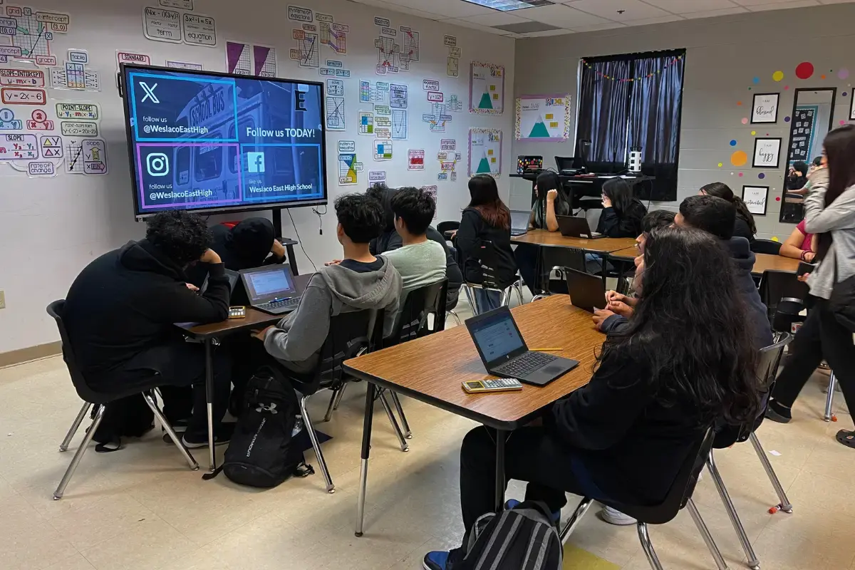 Students in a class viewing a digital signage display