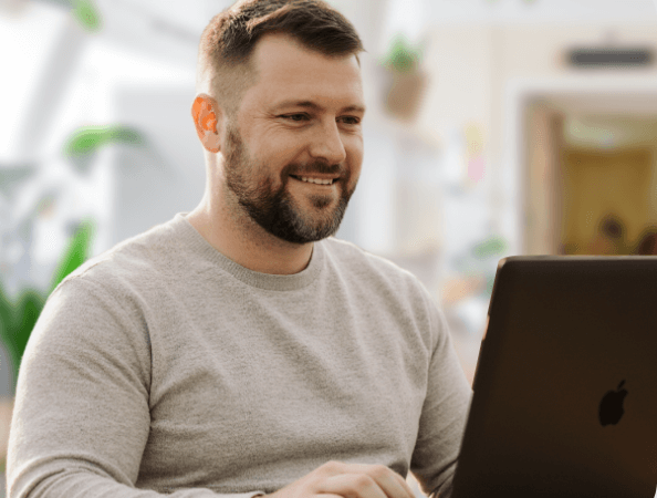 Caucasian man working at a laptop