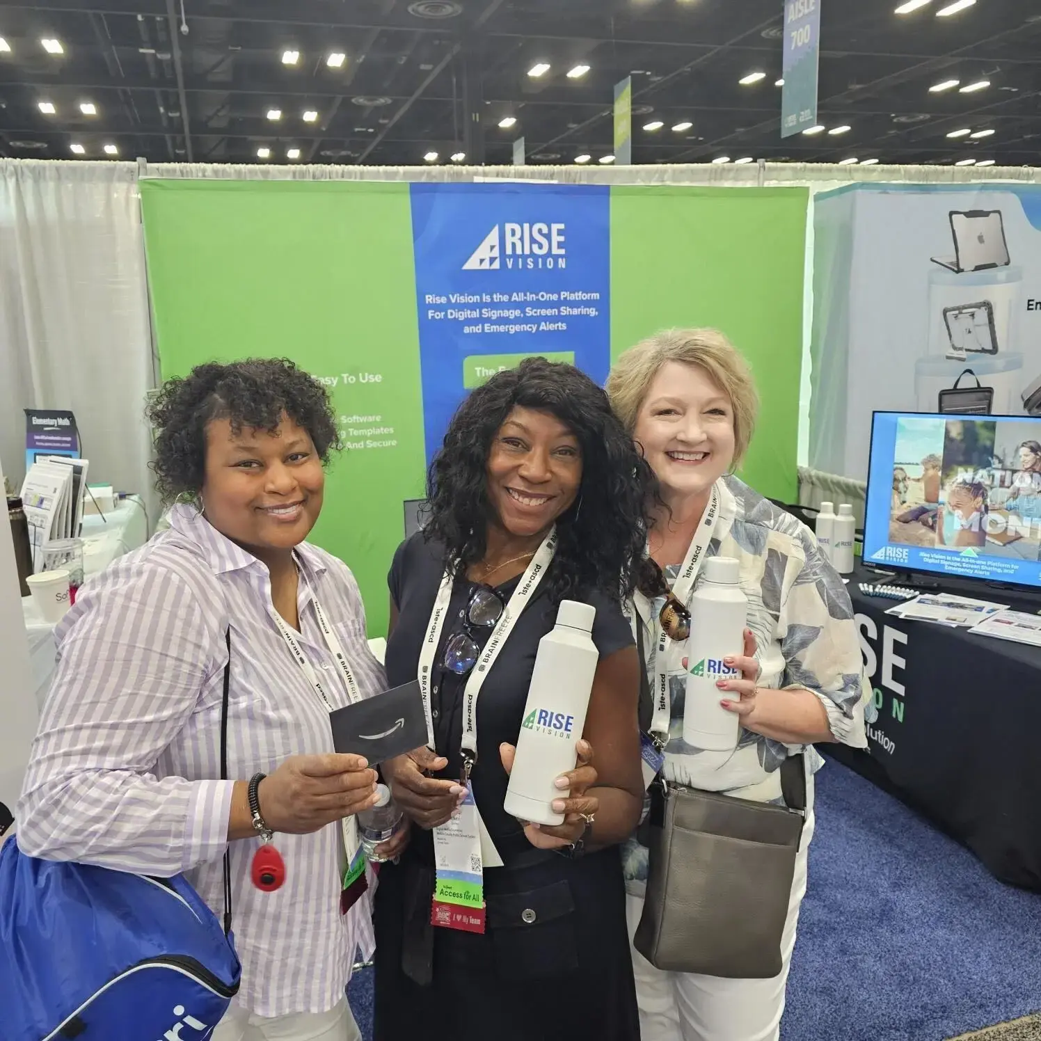 Three Rise Vision customers at an event