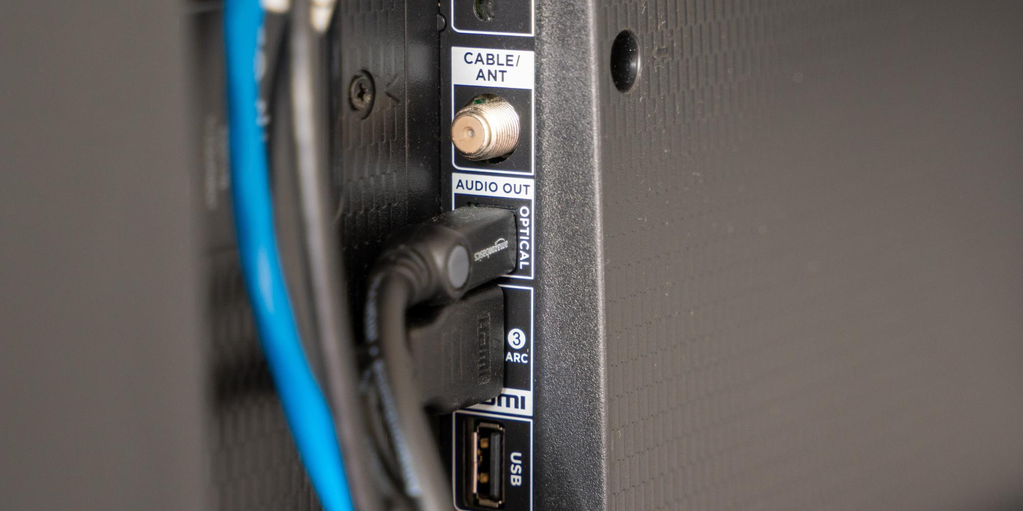 Close-up of cable ports on the back of a TV.