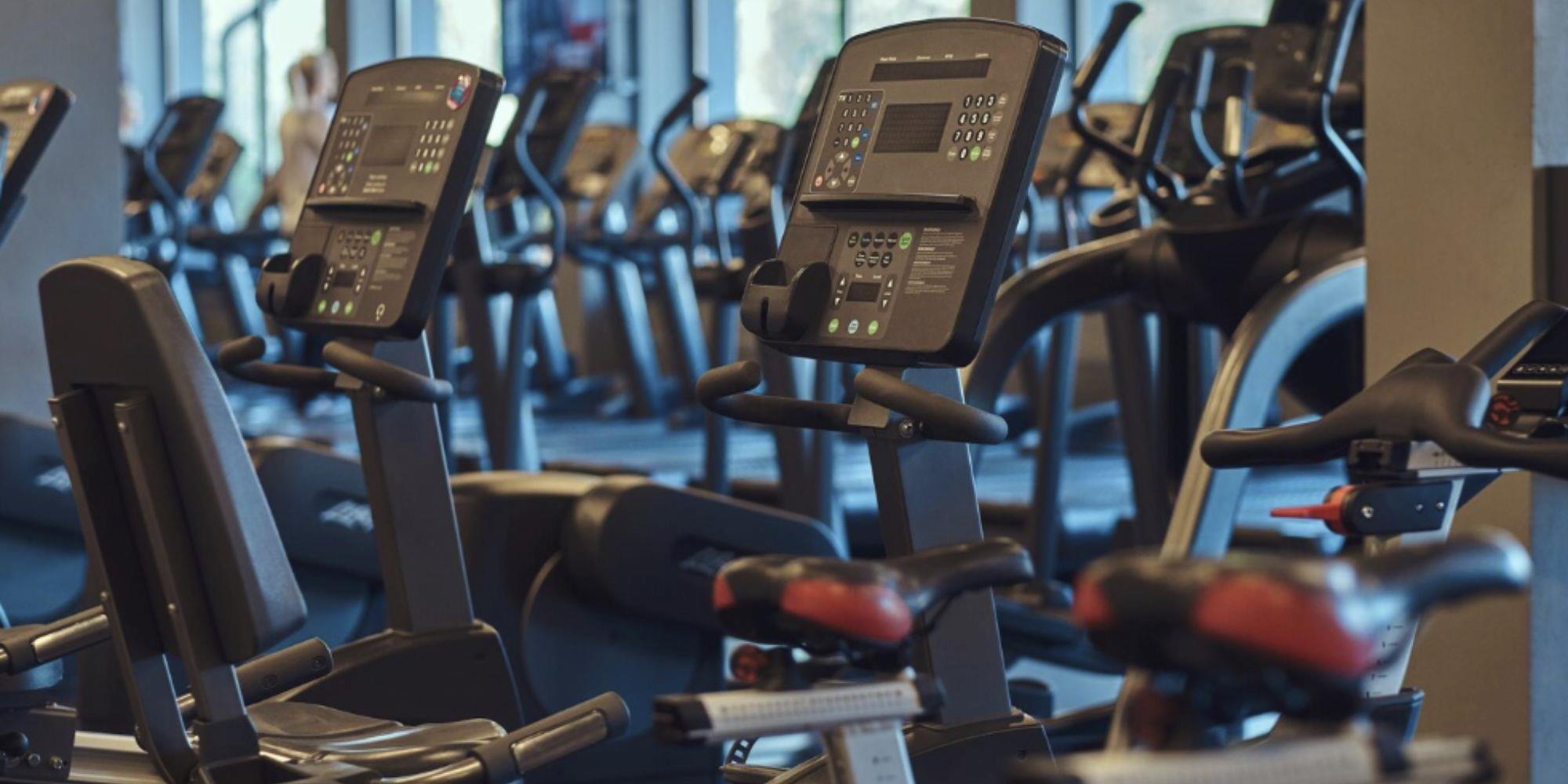 A photo of a gym interior featuring a number of gym equipment. 