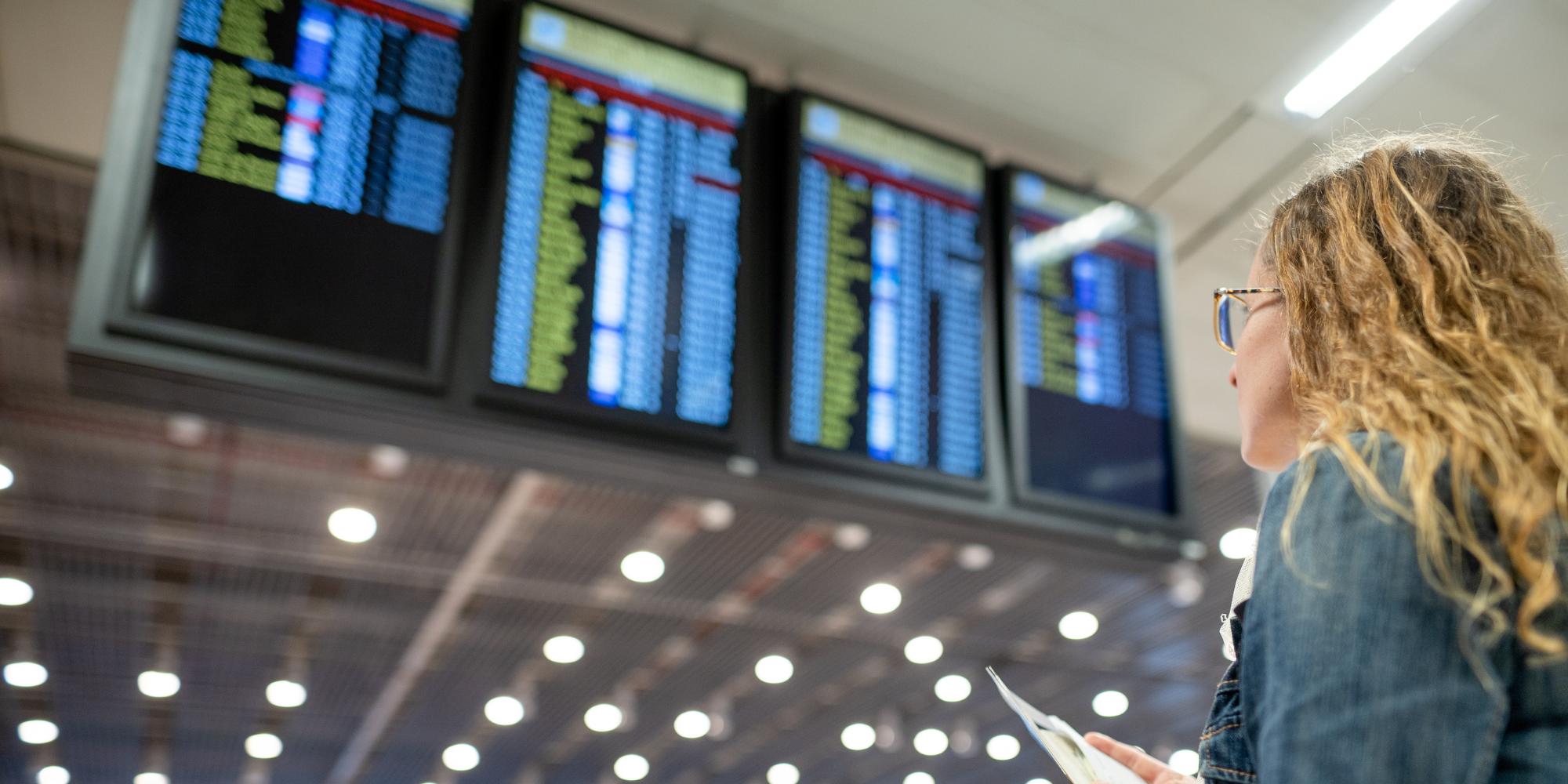 A digital signage screen in the middle of a transportation hub.