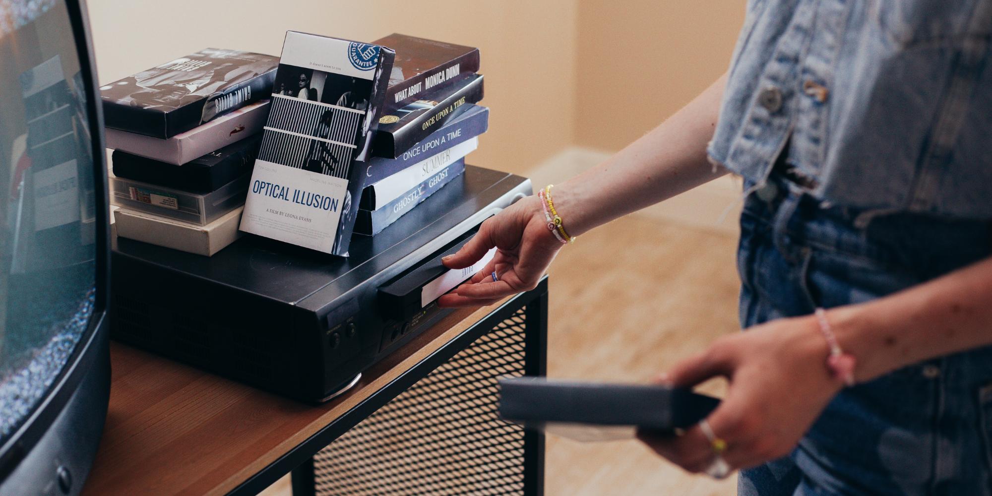 A video cassette being inserted into VCR.