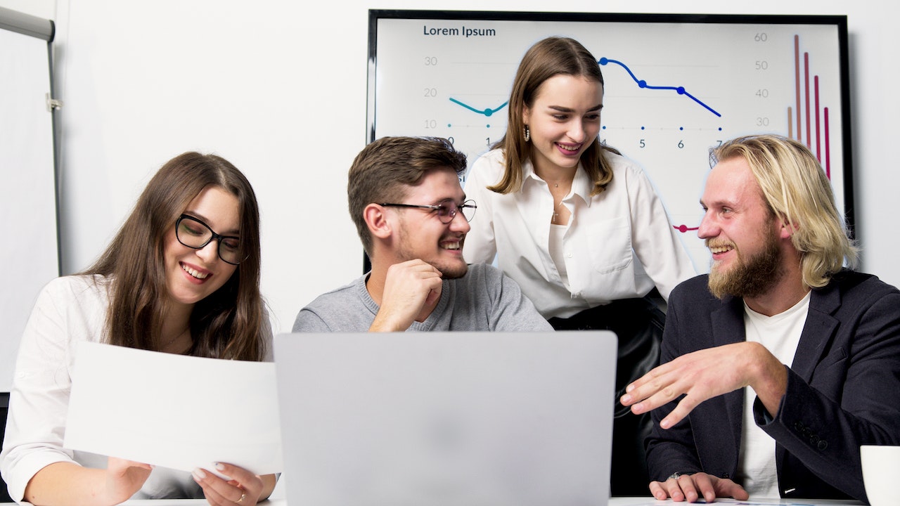 Corporate workers showcasing how to use digital signage for corporate communication.
