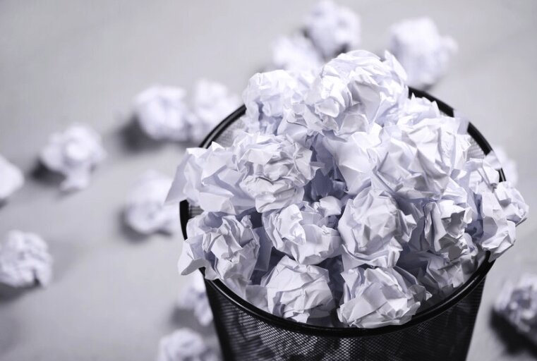 Paper waste in trashcan.