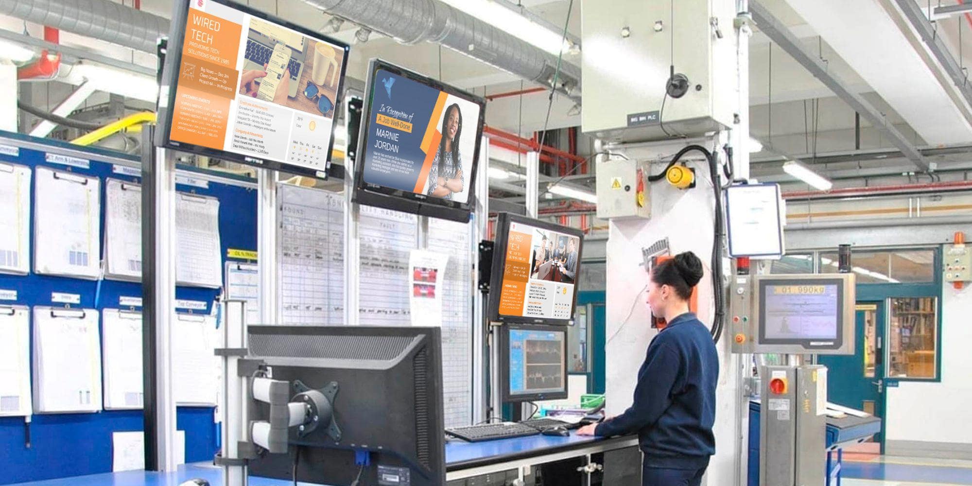 A worker surrounded by screens serving content with the help of enterprise digital signage.