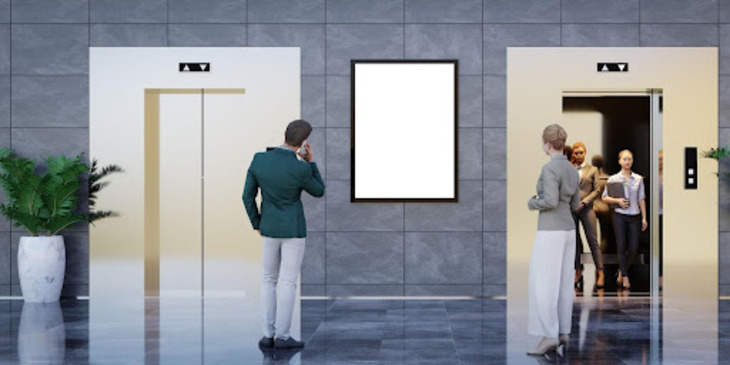 People standing in front of a digital signage display next to an elevator, promoting corporate social responsibility initiatives and sustainability practices.